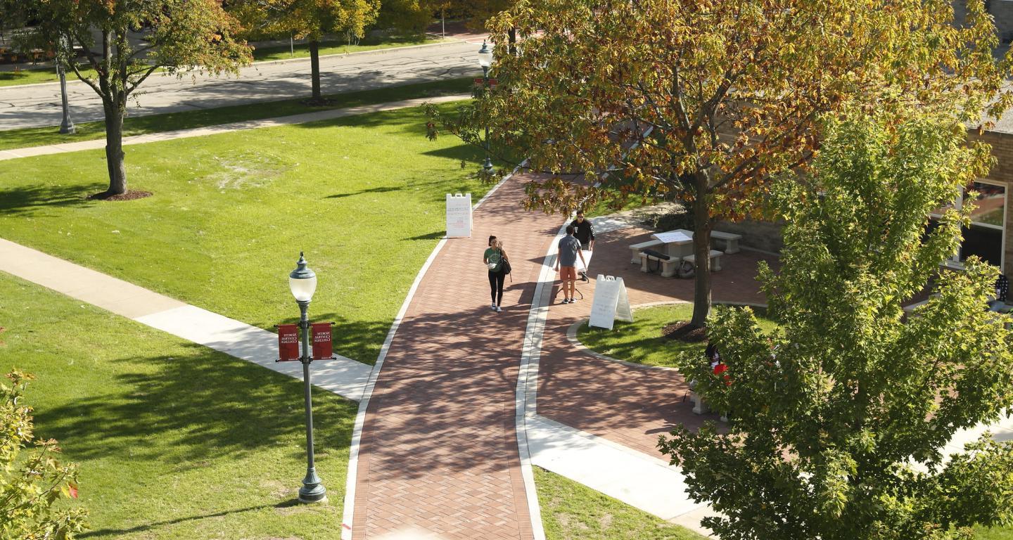 students walking on walkway through campus